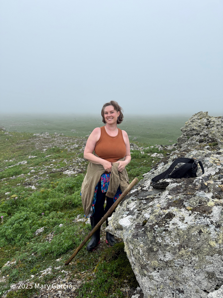 Person standing in dense fog near McKay's Folly on St. Paul Island, Alaska.