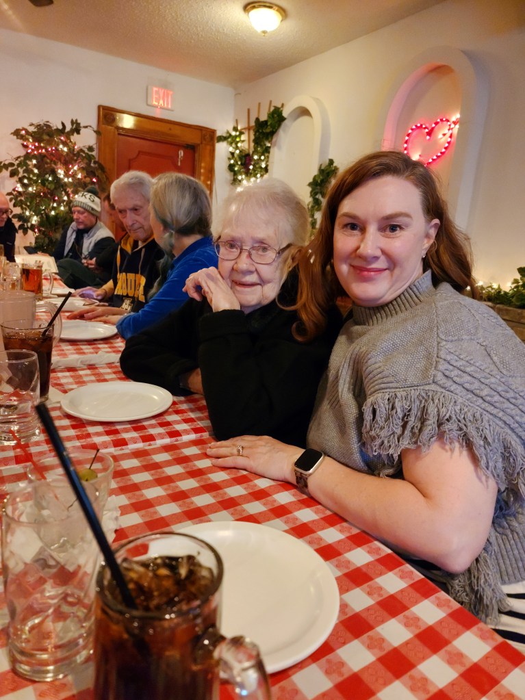Mary Garcia sitting beside her mother at DeMarini’s Pizza in Bay View, Wisconsin during a family dinner celebrating her father’s 90th birthday.